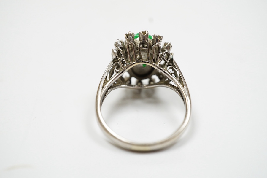 A white metal, jade and diamond set oval cluster ring, size N, gross weight 5.4 grams. Condition - fair to good